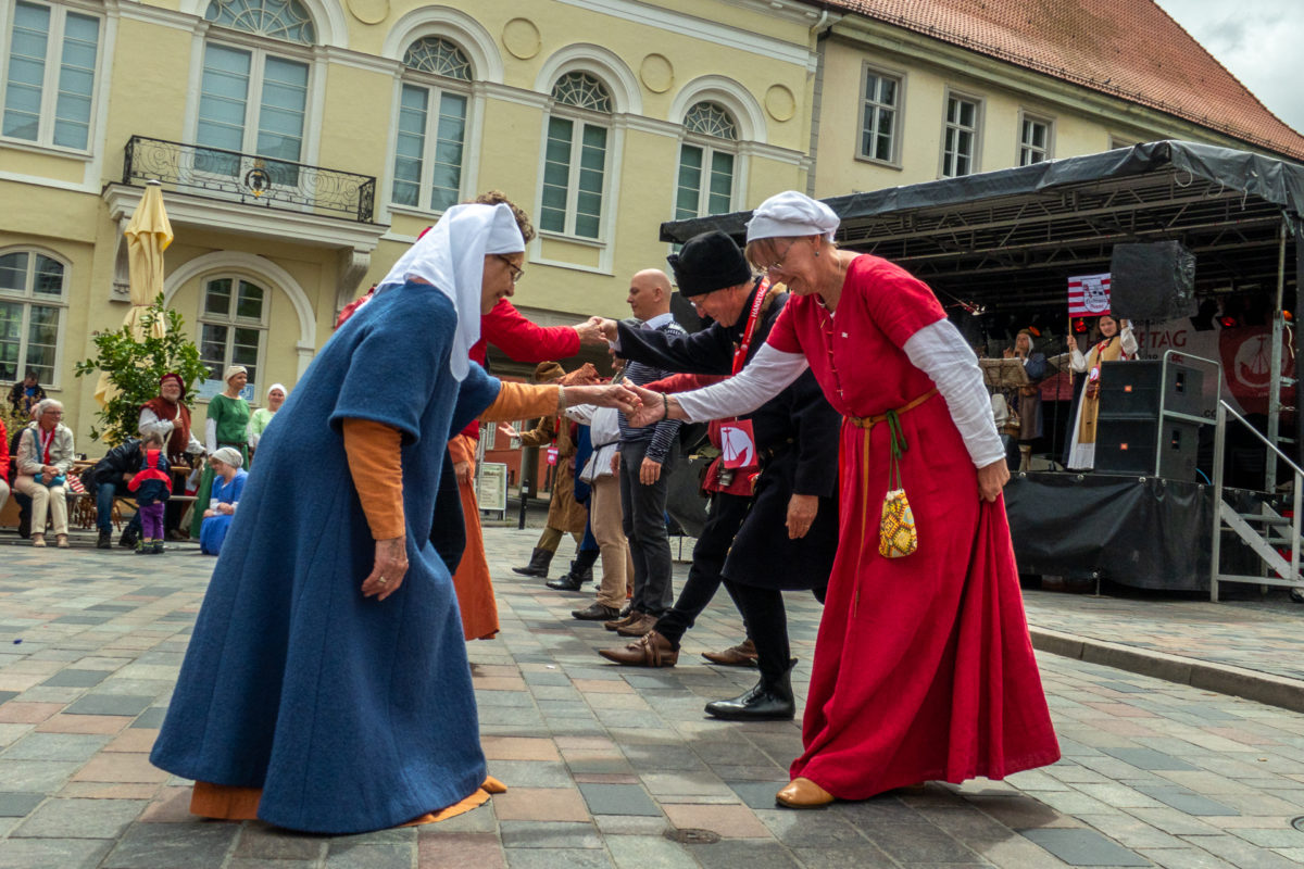 Historische Tänzer auf dem Uniplatz in blauen und roten Gewändern